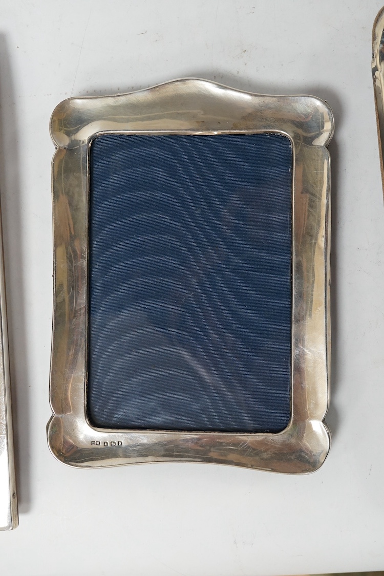 An Edwardian silver mounted photograph frame, King & Sons, Birmingham, 1907, 23.7cm, together with two later George V silver mounted photograph frames, Birmingham, 1917 and Birmingham, 1925. Condition - fair